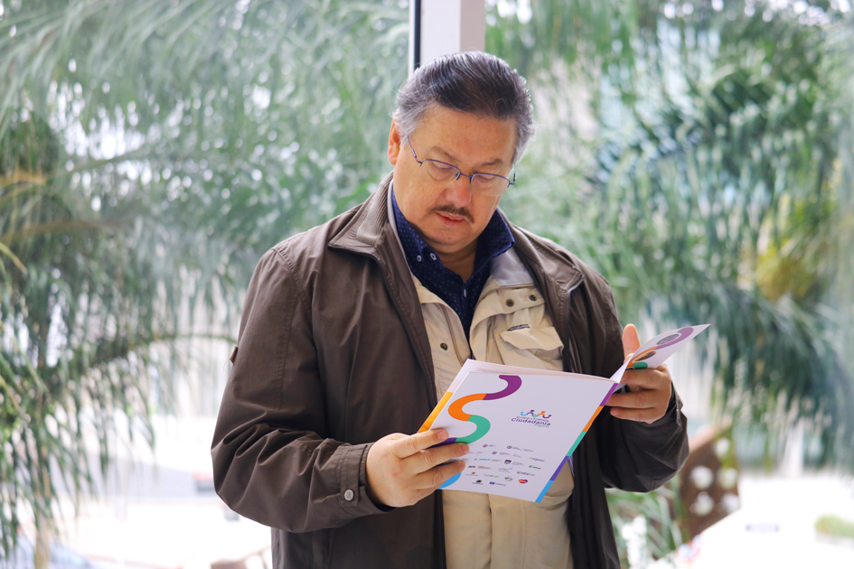 Un hombre mayor leyendo la guía