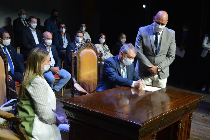 El intendente entrante Ing. GuillermoLopez firma el acta de asunción