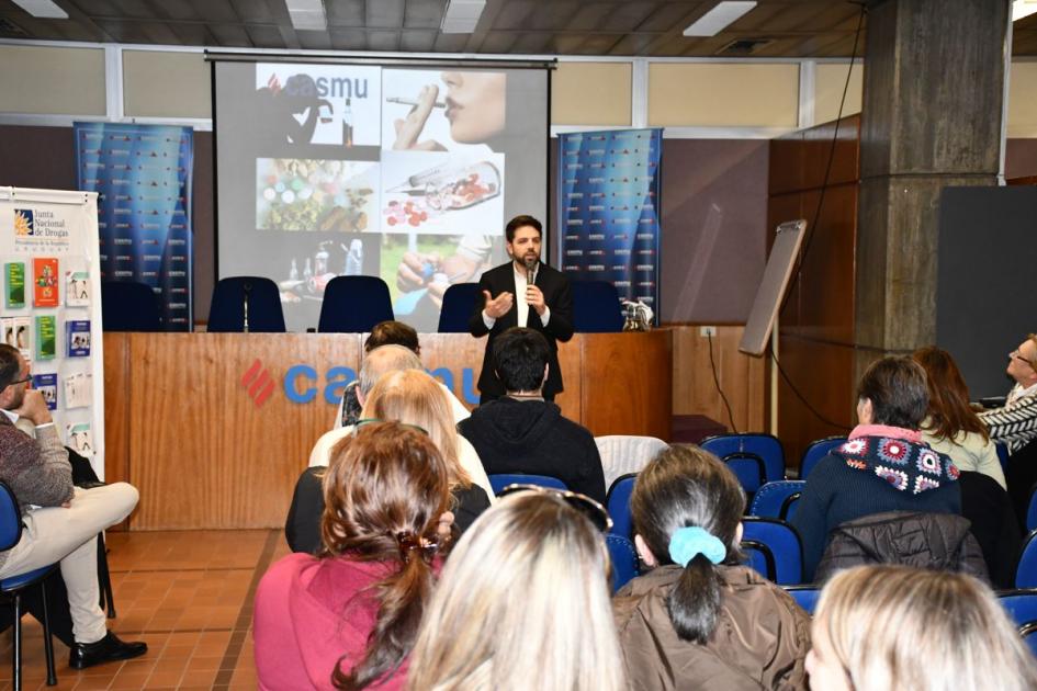 Secretario General de la Junta Nacional de Drogas, Diego Olivera, exponiendo. Vista del público desde atrás