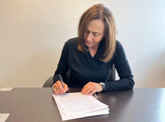 La directora Nacional de Aguas, arq. Viviana Pesce, firmando la resolución del primer expediente.