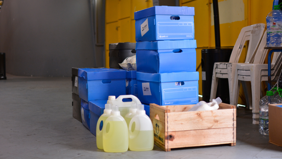 Una pila de cajas y productos de limpieza sobre una zorra de carga