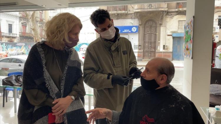 Fernanda Auersperg junto a usuario de refugio y peluquero en refugio Hotel Urban