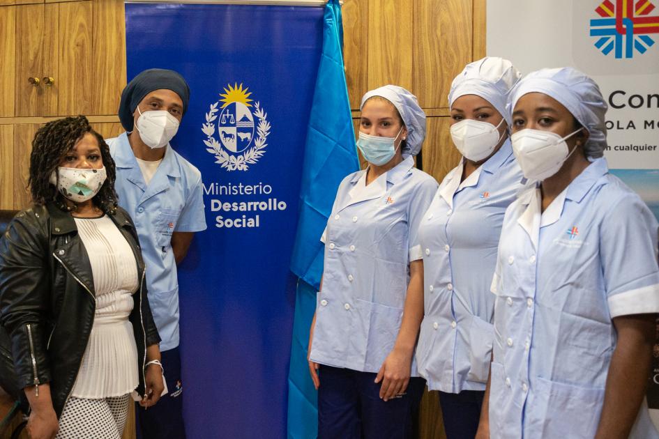 Bienvenida a participantes postulados desde los programas del ministerio que ingresan a trabajar en Asociación Española Cuatro mujeres y un hombre con sus uniformes de trabajo en el día que ingresan a la Asoc. Española