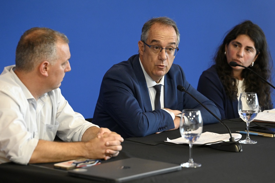Personas en mesa hablando al público.