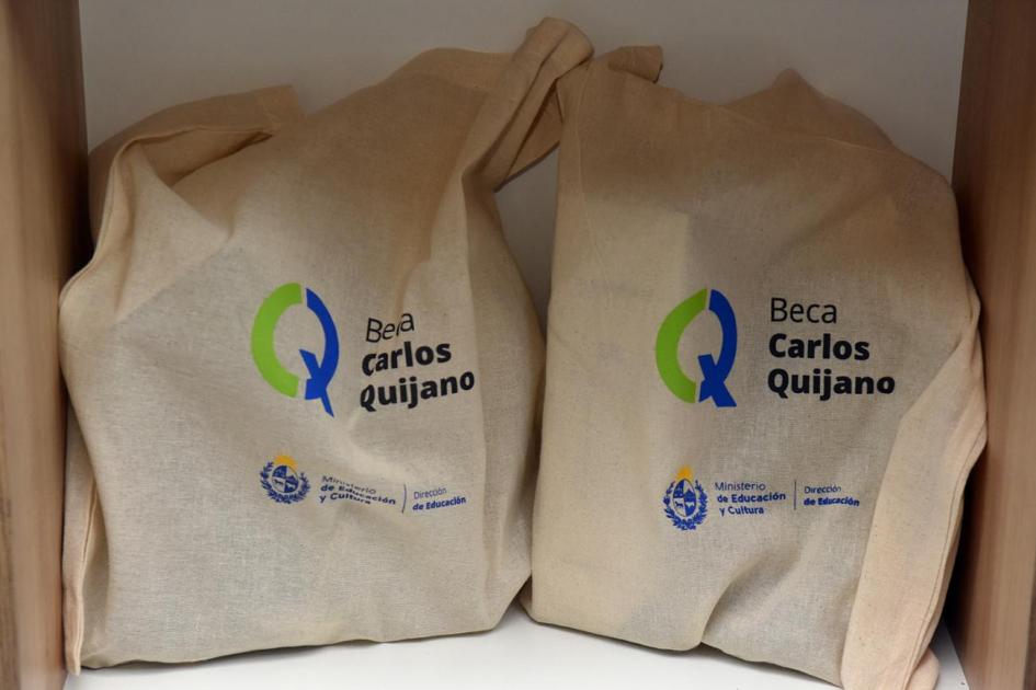 Dos bolsas de tela con logo BCQ. La misma contiene presentes para egresados de BCQ