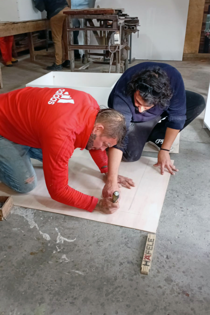 Partipantes del taller armando un mueble biblioteca Personas armando un mueble