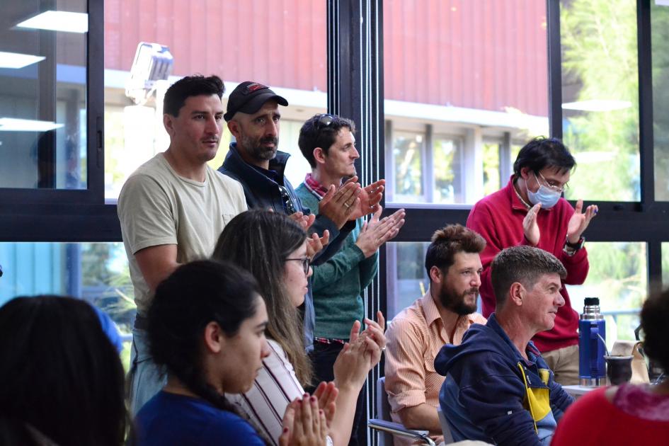 Personas de pie y sentadas aplaudiendo