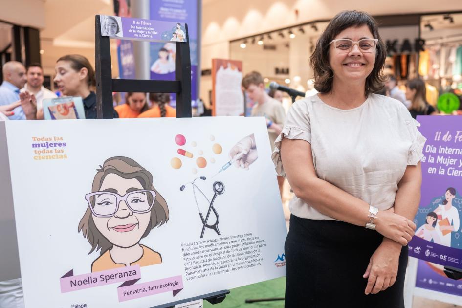 La pediatra y farmacóloga Noelia Speranza junto a su lámina en la muestra La pediatra y farmacóloga Noelia Speranza junto a su lámina en la muestra