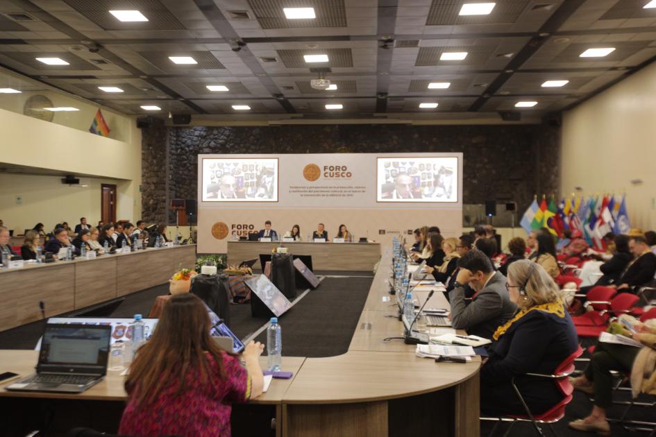 Personas sentadas alrededor de una mesa en sala de conferencias.