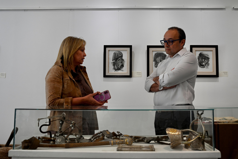 Autoridades paradas frente a objeto en exposición