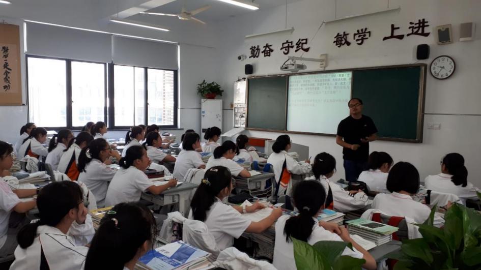 Jóvenes chinos prestando atención al profesor en el salón de clase