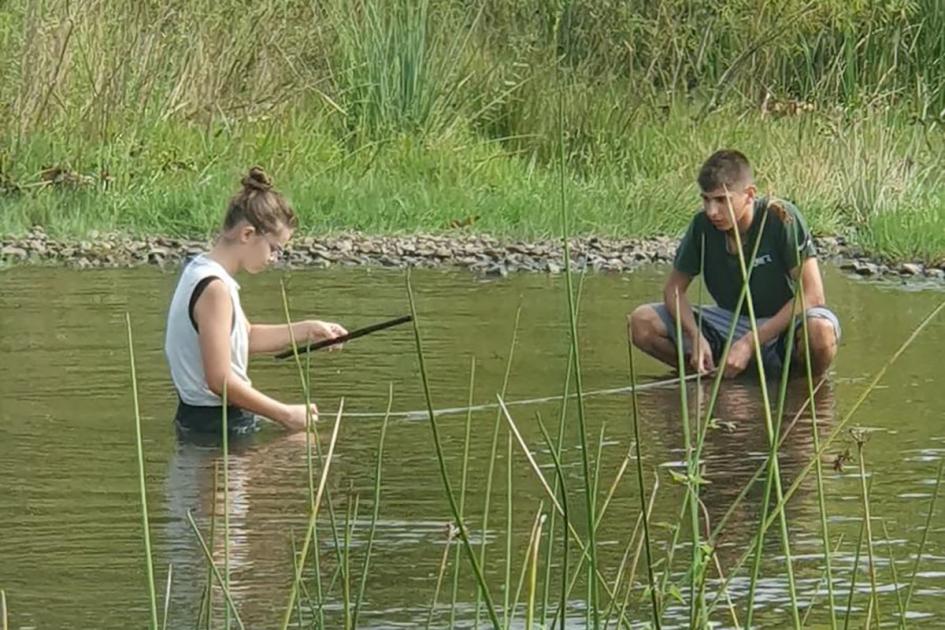 Campamento Latinoamericano de ciencias Estudiantes sacando muestras de un arroyo