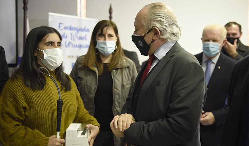 Ministro de Educación y Cultura, Pablo da Silveira con una beneficiaria