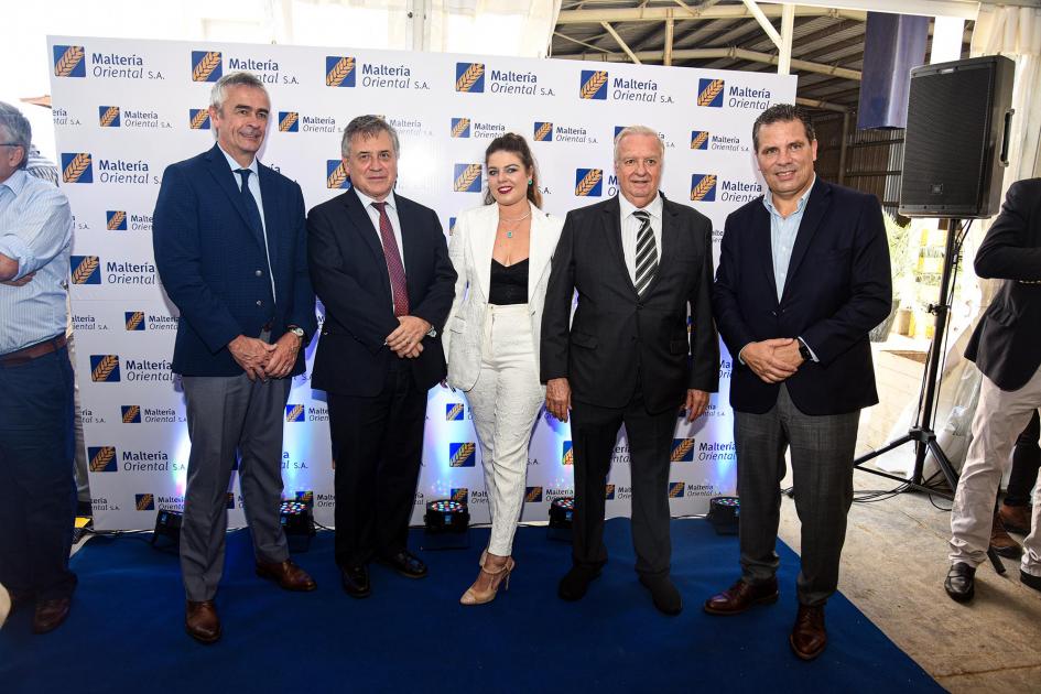 Ministro Omar Paganini y representantes de la empresa Paganini posa para la foto con integrantes de la empresa; detrás hay un banner de MOSA