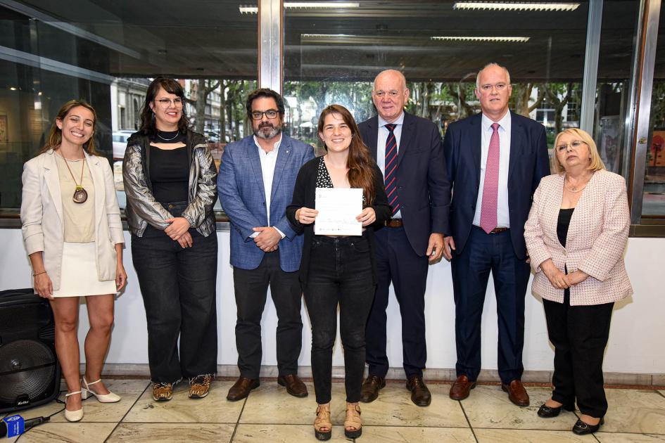 Autoridades con una mujer que sostiene un papel