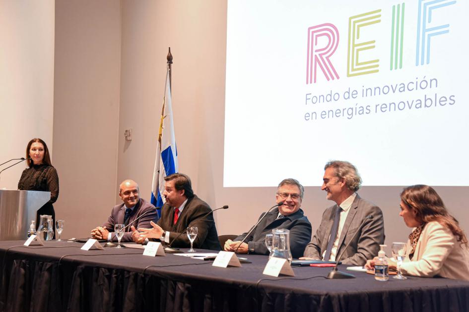 Mesa de autoridades Mesa de autoridades; detrás un cartel de colores dice Reif. El ministro Paganinini sonríe