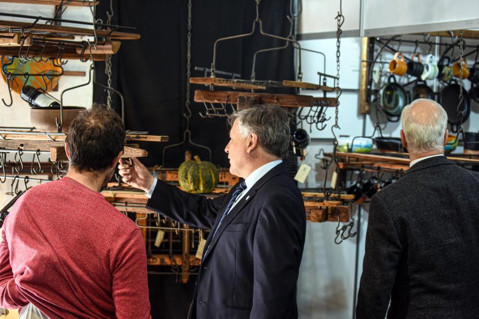 Ministro Omar Paganini observa artesanías de herrería junto a un artesano