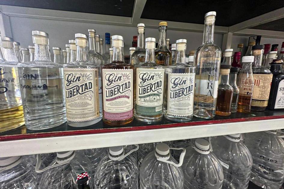 Villa Lima diversificó su producción y abrió la Destilería Libertad donde, por ejemplo, fabrica gin Frascos de bebidas destiladas sobre una superficie; tienen la marca Libertad