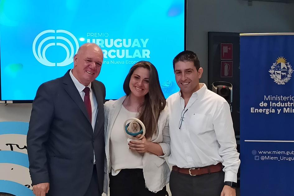 El subsecretario Walter Verri entrega un premio a una mujer, que lo tiene en su mano