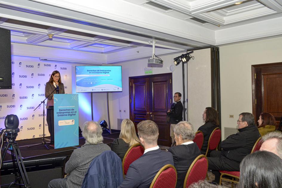 El evento se desarrollo en el Hotel Radisson Montevideo Al fondo, Facio habla desde un atril; frente a ella, el público