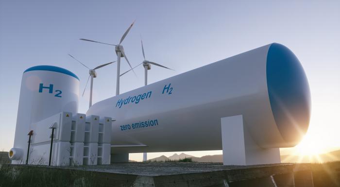 Portada del Monitor Energético n.º 17 Portada: equipo de hidrógeno verde; detrás, molinos de viento