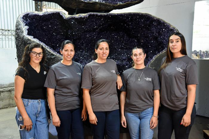 Mujeres trabajadoras del sector minero, en Artigas Cinco mujeres jóvenes frente a una amatista de gran tamaño