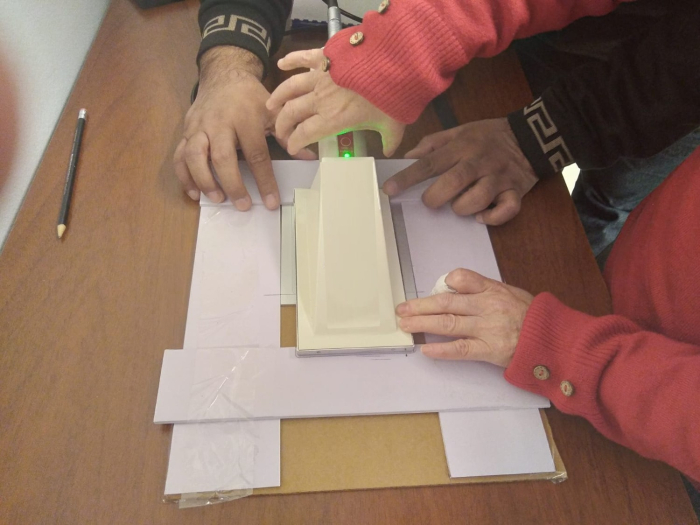 Misión de experto al LSMRI - DINATEN, MIEM manos sosteniendo un detector para calibrarlo