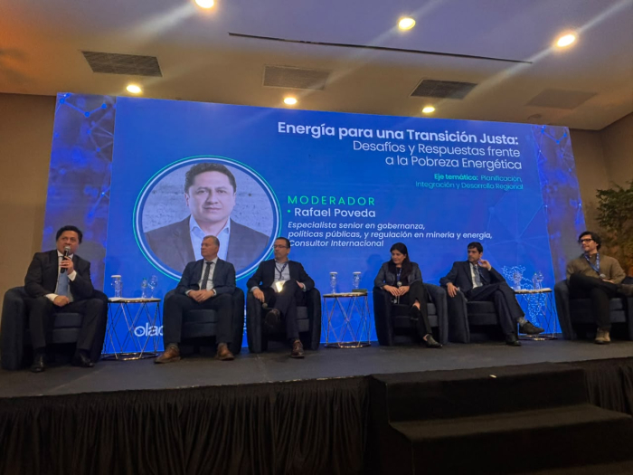 Todos los integrantes del panel sobre pobreza energética, sentados; detrás, pantlala