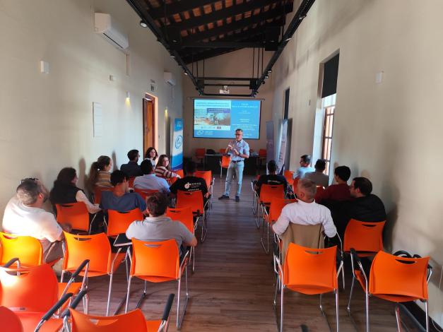 Personas asisten a un curso; al fondo, pantalla