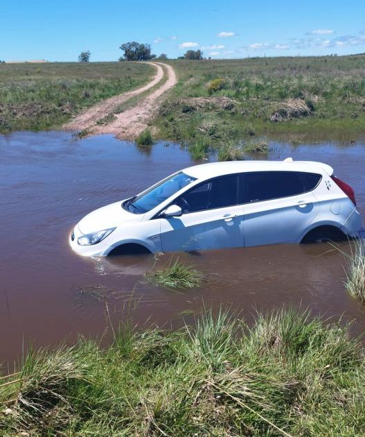 Calzada sobre Arroyo Porongos crecida. Auto arrastrado por la corriente