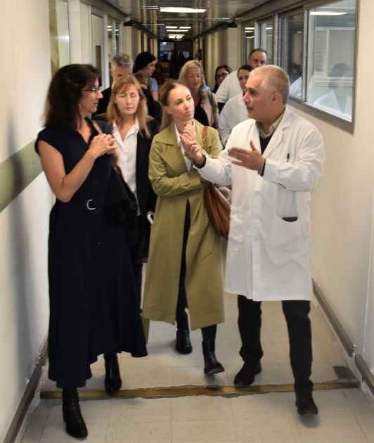 personas caminando por el pasillo de policlínicas del hospital