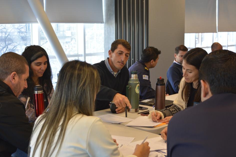 Analizando la evaluación de una simulación. participantes sentados alrededor de una mesa