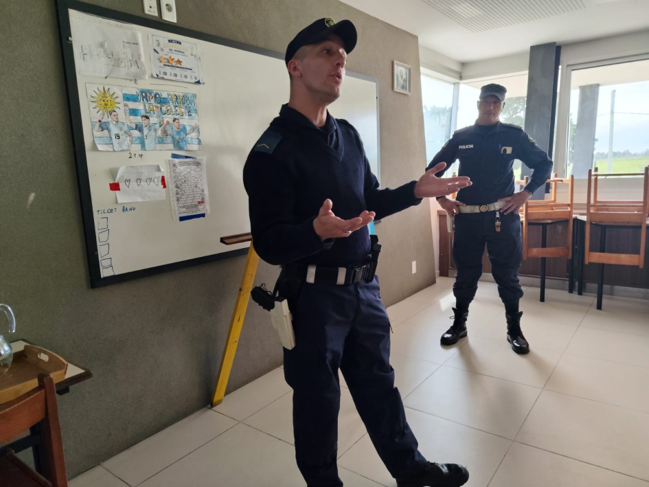Instructores de Policía de Tránsito imparten educación vial en la Fundación Los Pinos Policía parado de frente a niños explicando la importancia de la seguridad vial