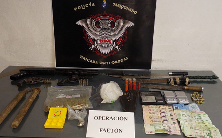 Operación "Faetón" armas, municiones, dinero y sustancia estupefaciente incautada, exhibida sobre una mesa