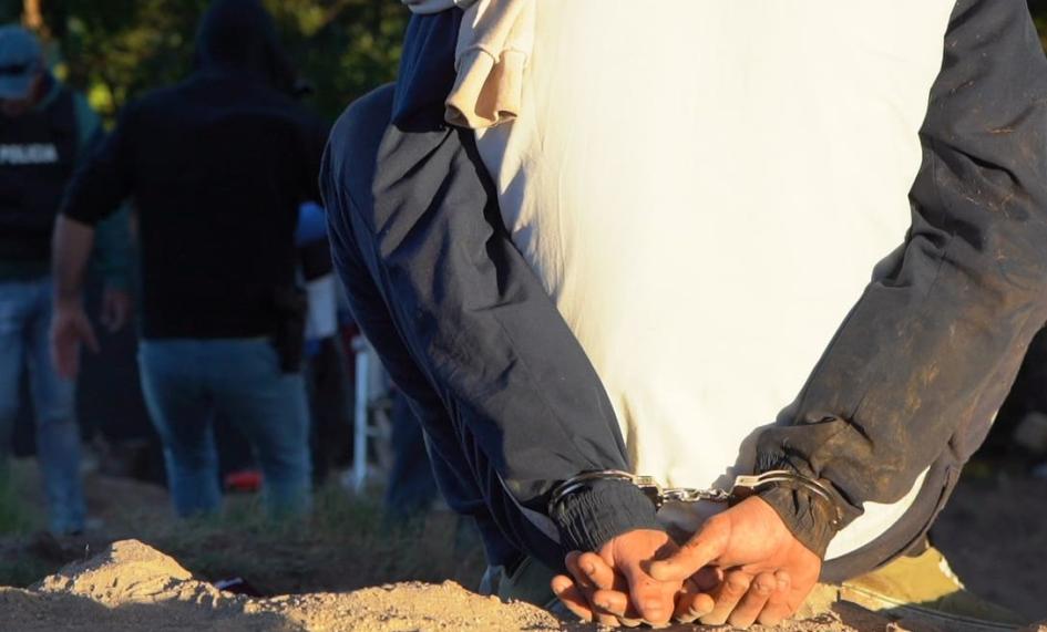 Hombre condenado por rapiña persona sentada en el piso con las manos esposadas en la espalda