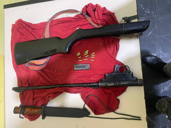 Rifle incautado, desarmado con culata, cañón, cargador y municiones.