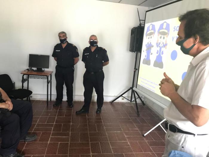 especialista de salud hablando y autoridades policiales escuhando