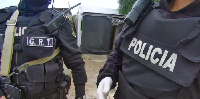 Dorsos de dos policías con identificación 