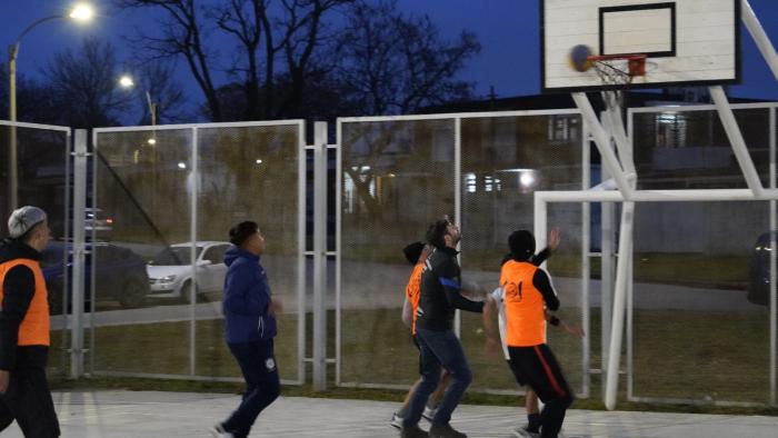 jovenes junto al ministro Martinelli jugando al básquetbol