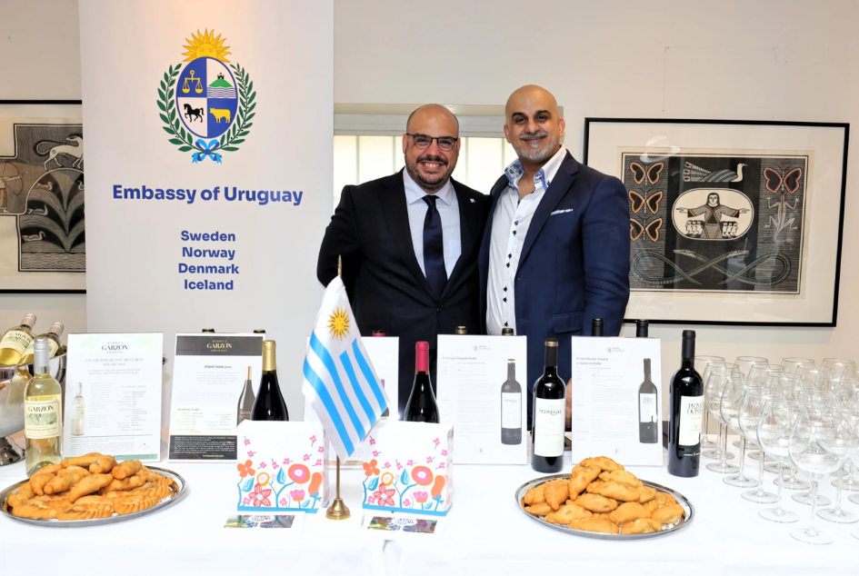 Uruguay's stand at the event Two people behind Uruguay's stand at the trade promotion event