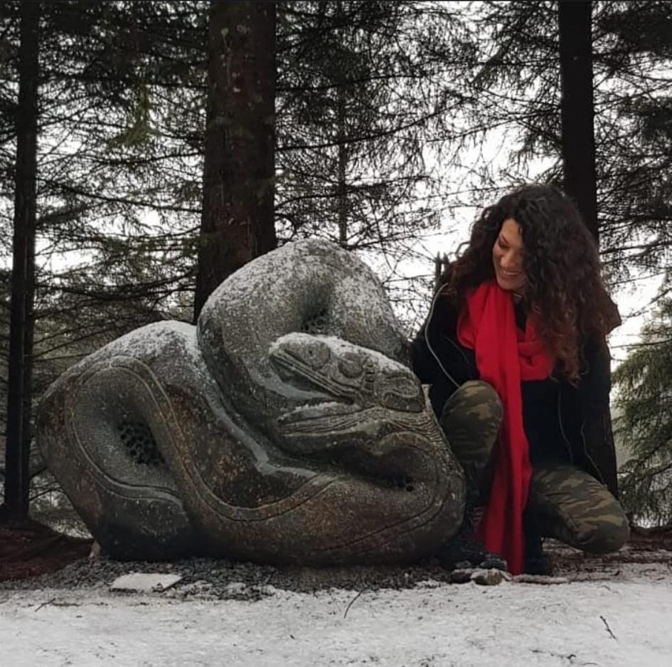 Uruguayan artist Gissella García Uruguayan artist Gissella García posing next to one of her stone sculptures, with a snowy landscape