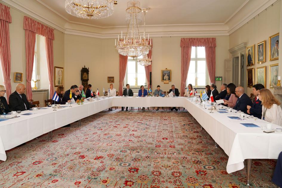 Meeting participants Large table with meeting participants seated