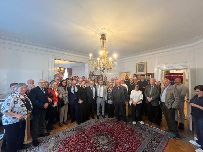 Compatriots and Embassy officials standing and facing forward, posing for the photo