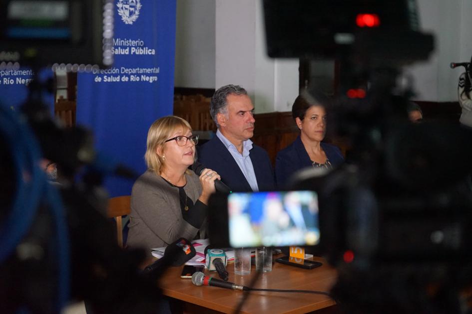 Ministra, Presidente y Directora General de la Salud en conferencia de prensa Lustemberg junto al Presidente brindan conferencia de prensa. En primer plano el visor de una cámara