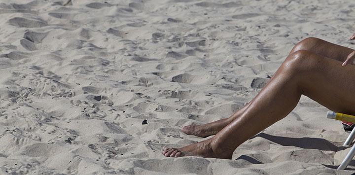 Imagen de piernas de una persona en la arena
