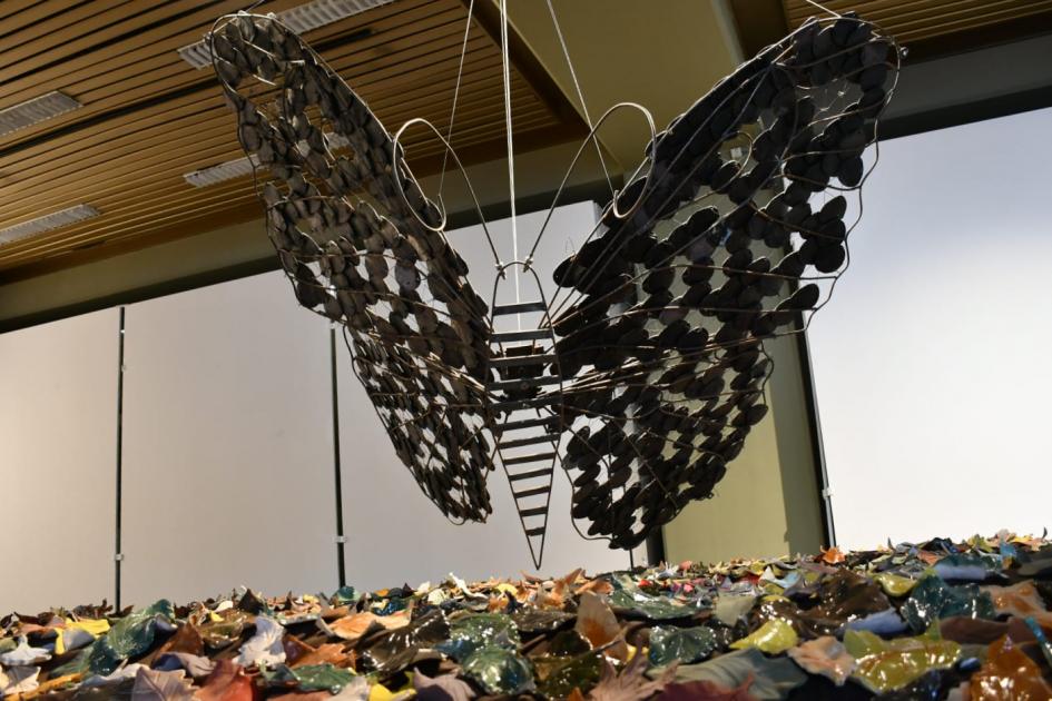 La causa del viento Obra escultórica: mariposa de grandes dimensiones con hojas debajo