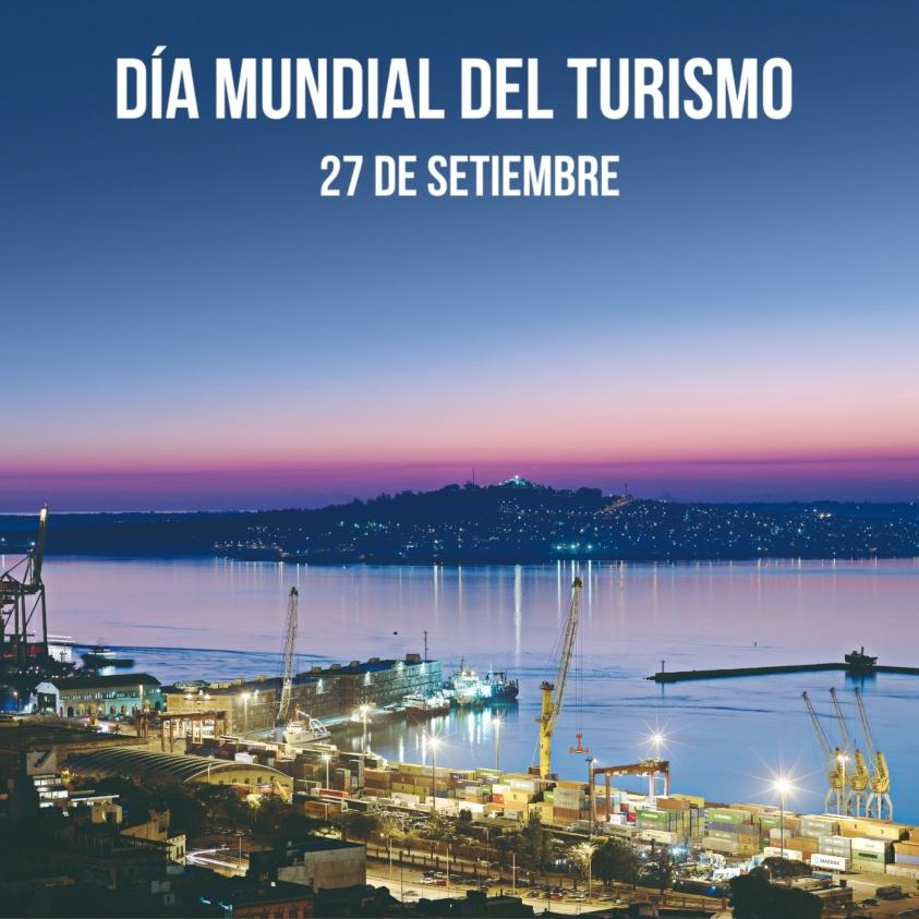 Vista del puerto de Montevideo con grúas con letrero que dice "Día Mundial del Turismo, 27 de setiembre