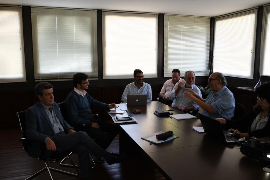 Sala de reuniones con representantes de ASSE y Dinot, autoridades y equipos técnicos de ambas instituciones sentados alrededor de una mesa dialogando