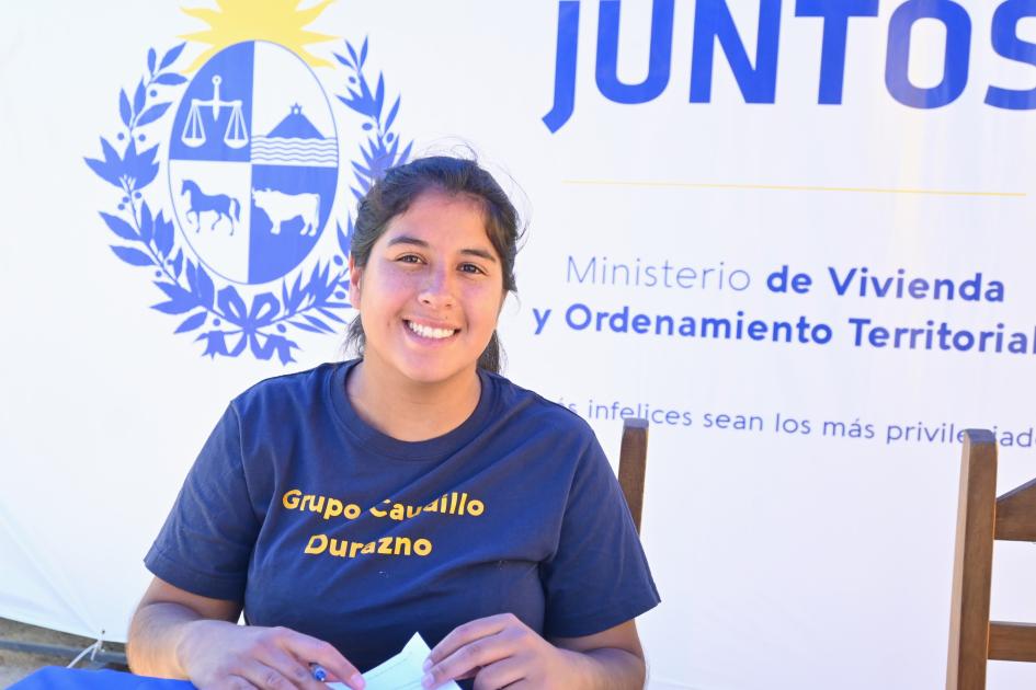 Participante de Juntos firma los documentos de su nueva vivienda 