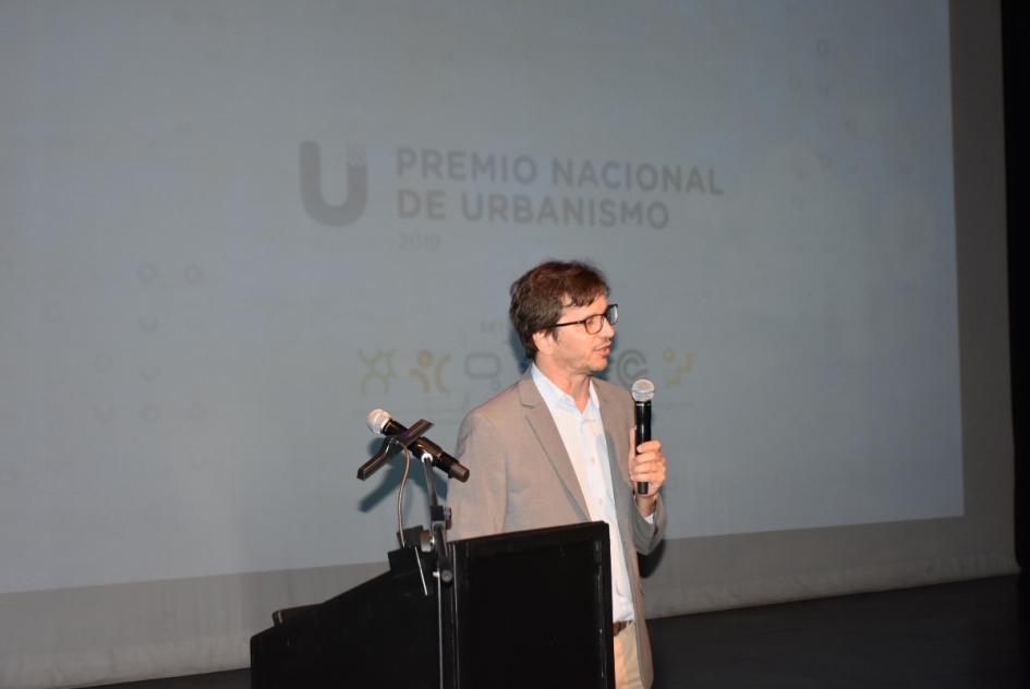 El director nacional de Ordenamiento Territorial José Freitas en el escenario hablándole al público 